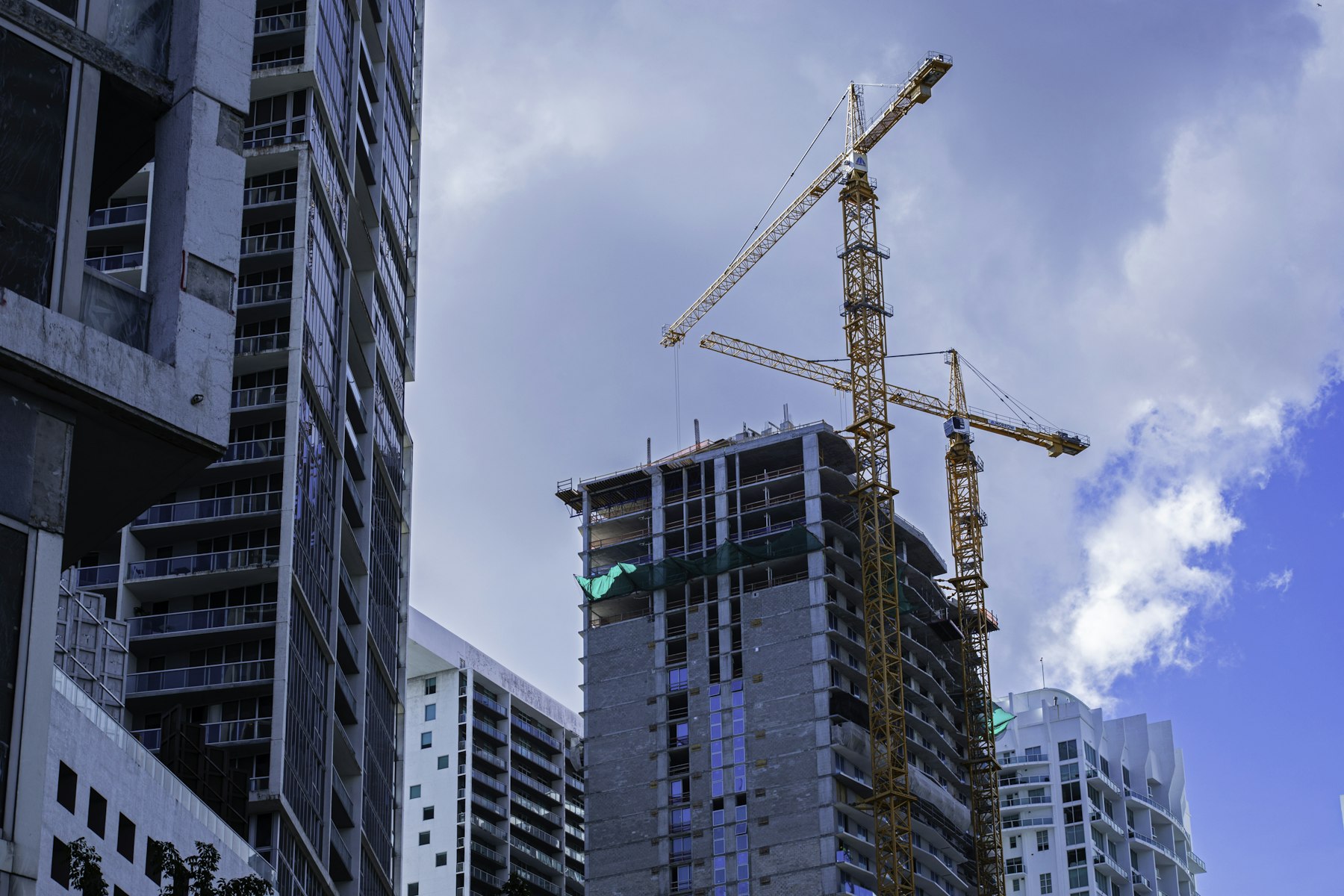 Residential tower under construction with tower cranes